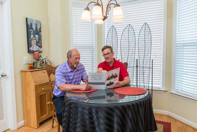 dealer and customer at kitchen table