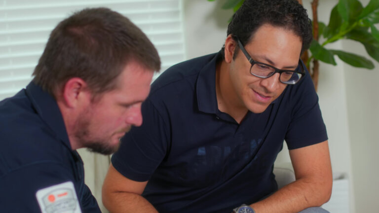 Custom air conditioning and air quality technician discussing hvac with a homeowner