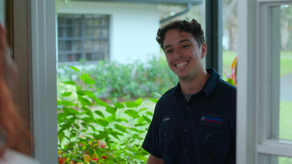 Custom air conditioning and air quality technician greeting a customer