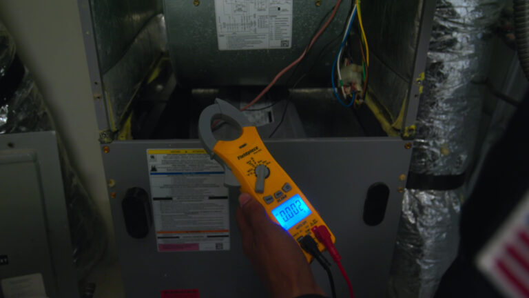 Custom air conditioning and air quality technician inspecting refrigerant connections