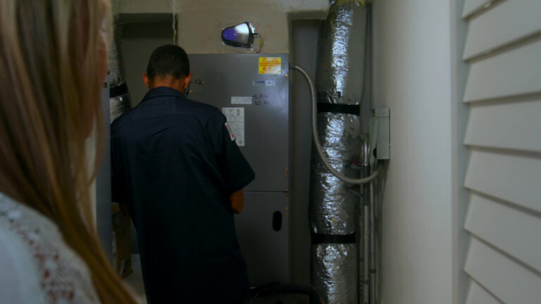 Custom air conditioning and air quality technician performing routine maintenance