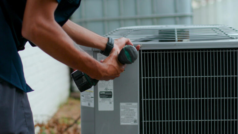 Custom air conditioning and air quality technician performing routine maintenance on an HVAC system