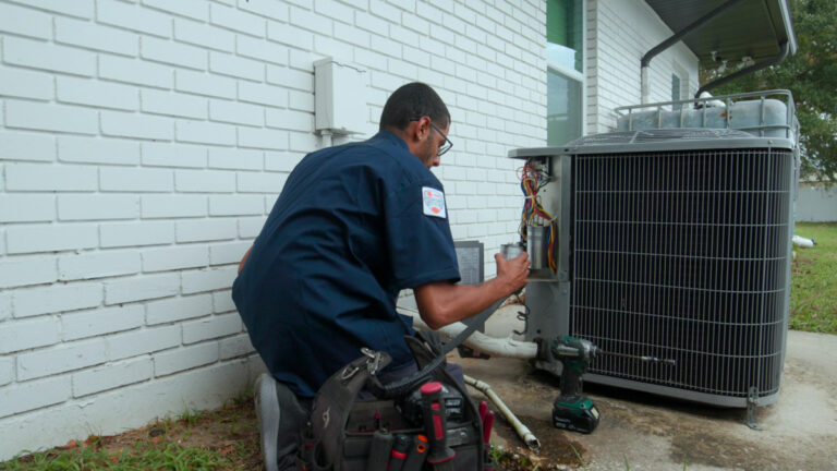 Custom air conditioning and air quality technician replacing worn out components in an air conditioning system