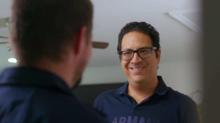 Homeowner consulting with a custom air conditioning and air quality technician about repairs